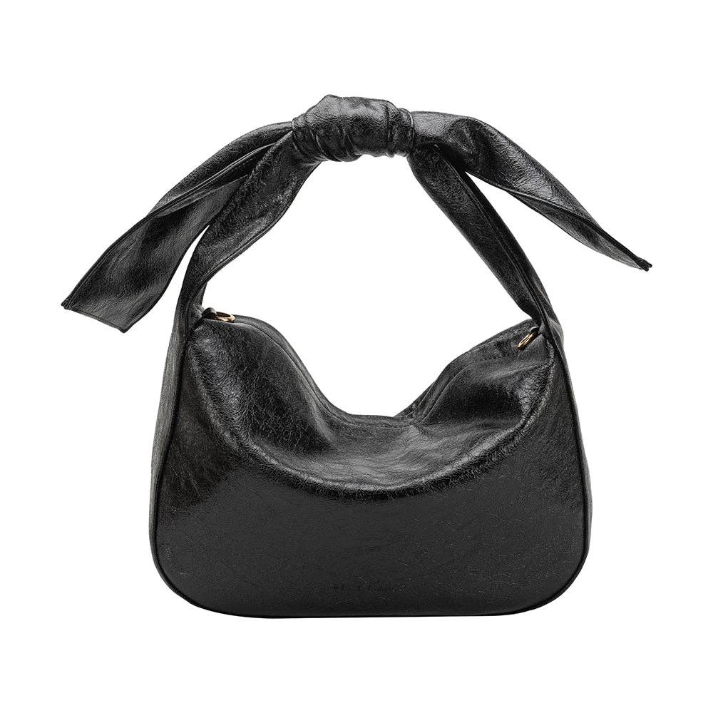 Black handbag with a bow strap on a white background