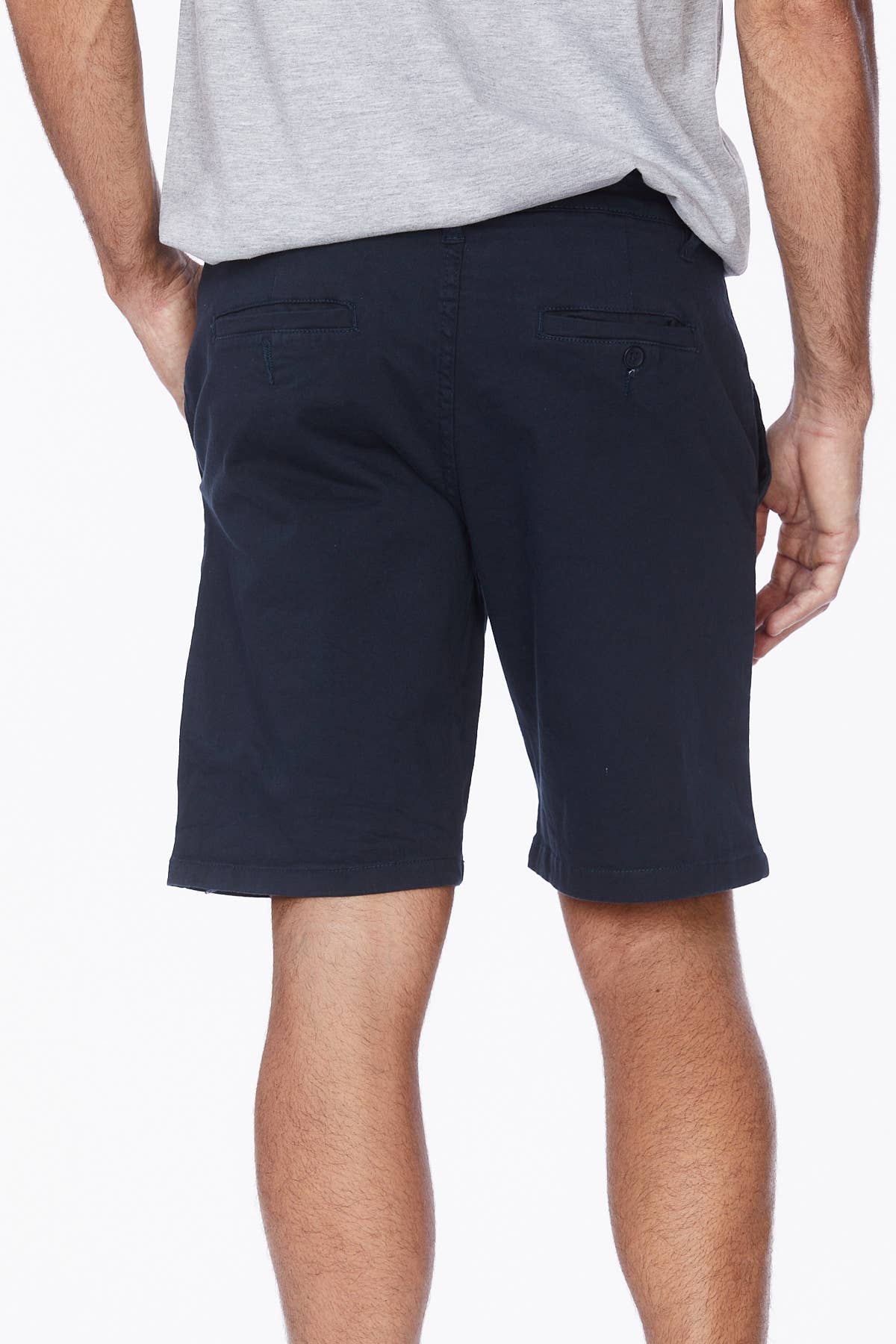 Male model wearing navy shorts with a grey tee.