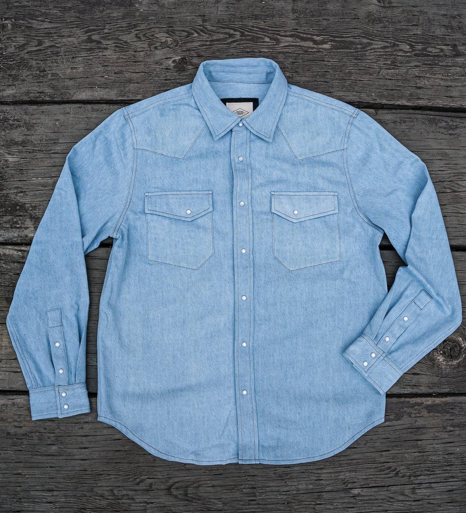 Light blue denim shirt on a wooden surface