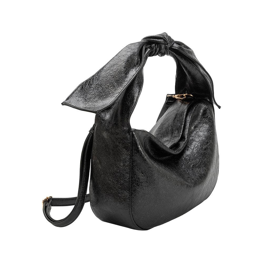 Black vegan leather handbag with a bow strap featuring crossbody strap on a white background