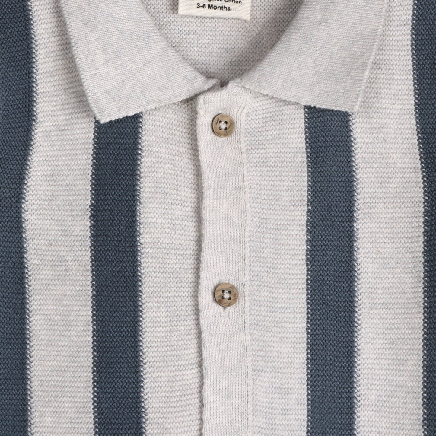 close up of grey knit baby collared top with navy stripes