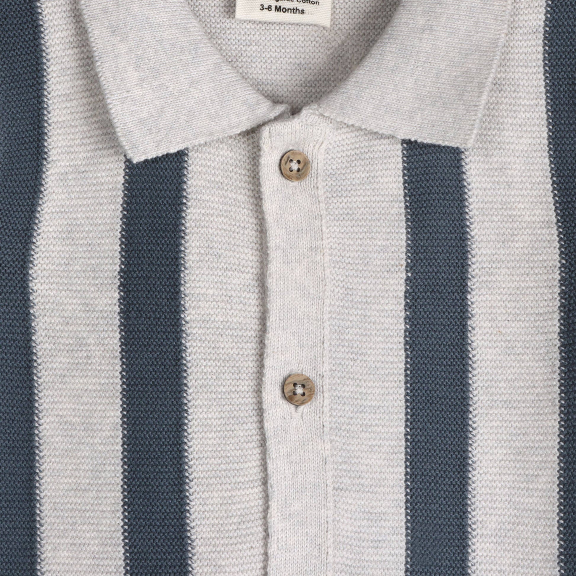 close up of grey knit baby collared top with navy stripes