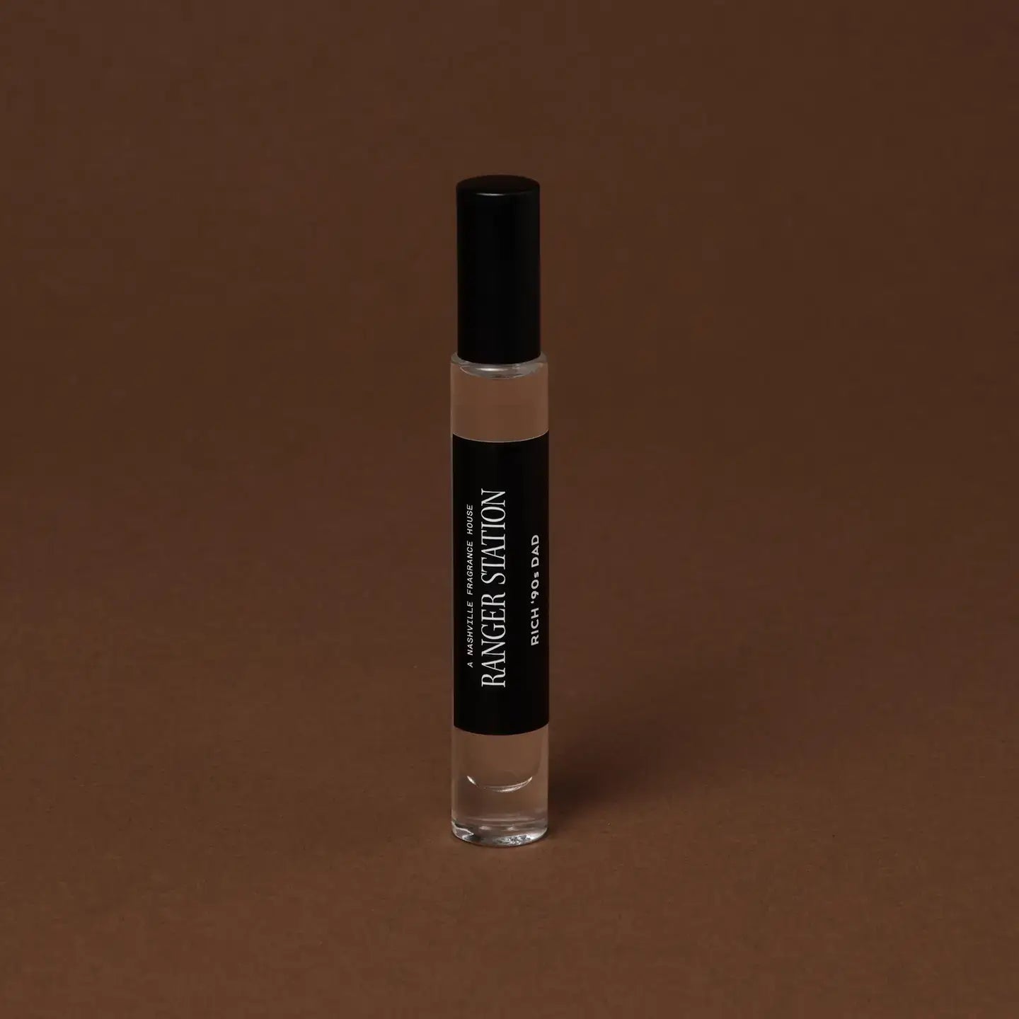 bottle of perfume with brown background
