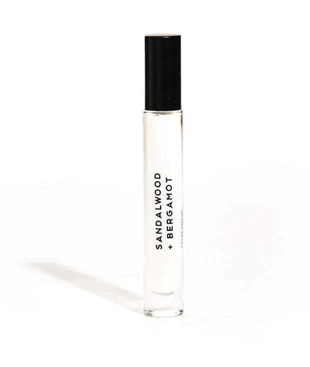 clear perfume bottle labeled sandalwood + bergamot