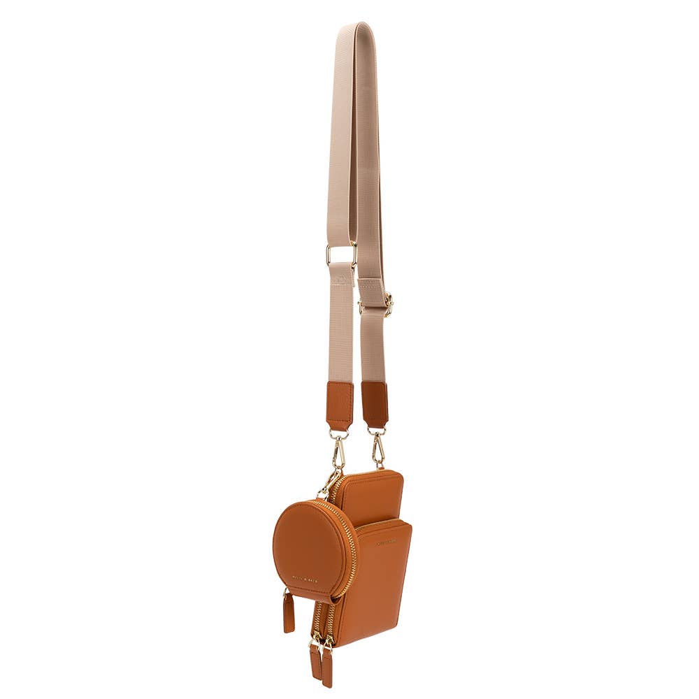 side view of tan crossbody against white background