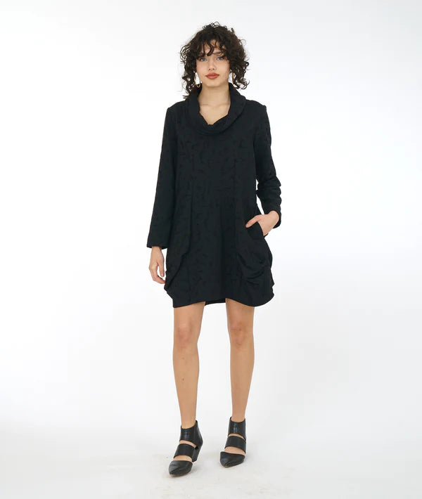 model is wearing a short black textured dress