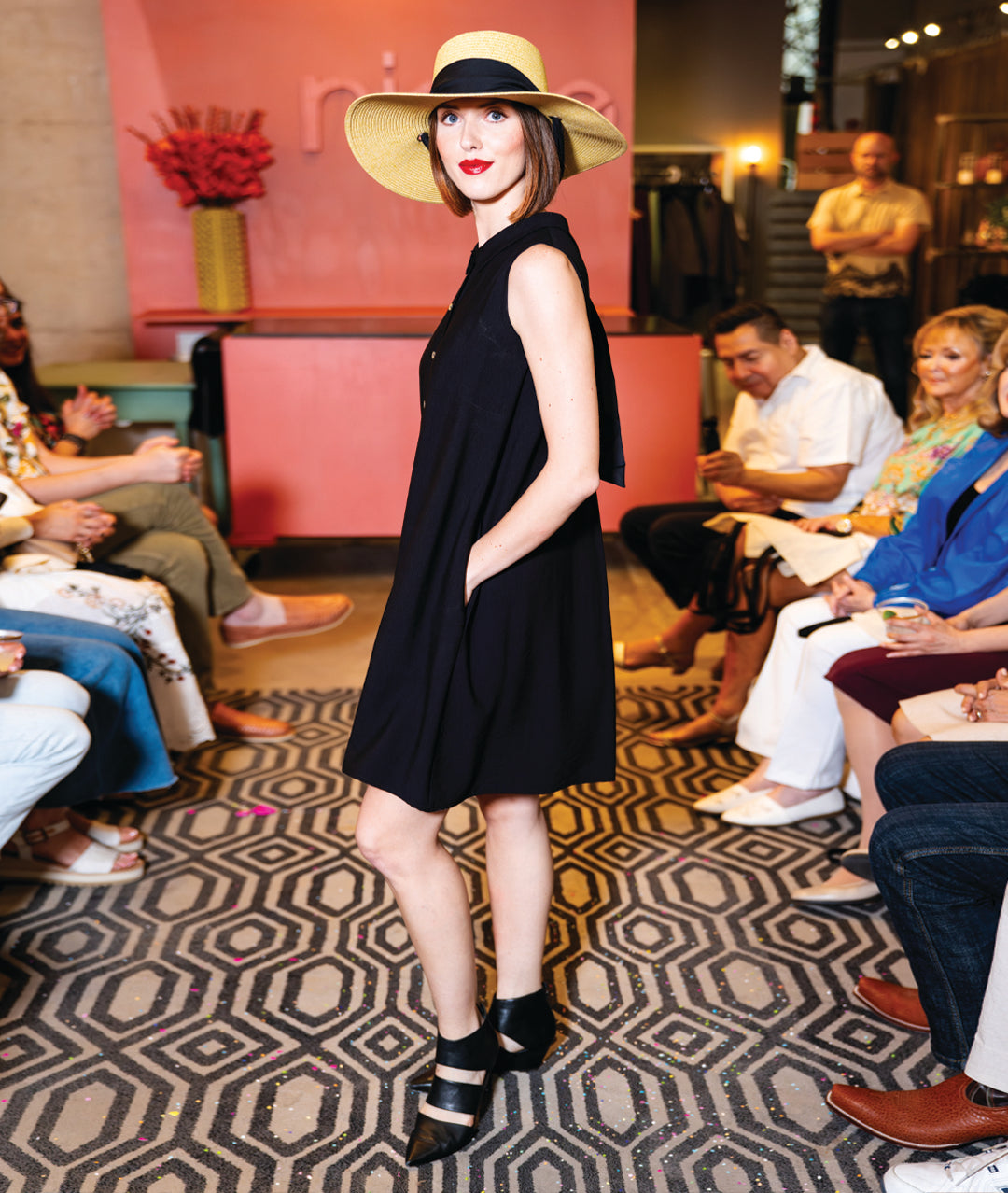 model in a black button down sleeveless shirt dress