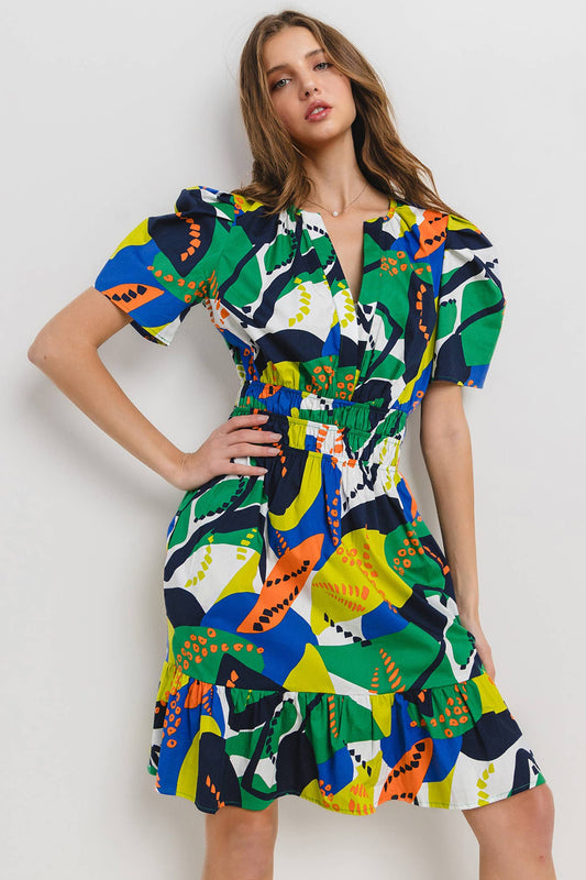 model is wearing a tropical printed short dress with puffy sleeves