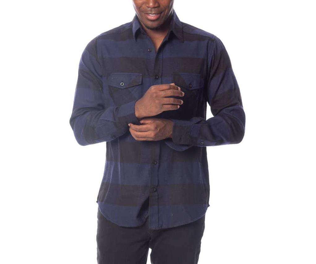 male model wearing a blue & black flannel shirt and black jeans