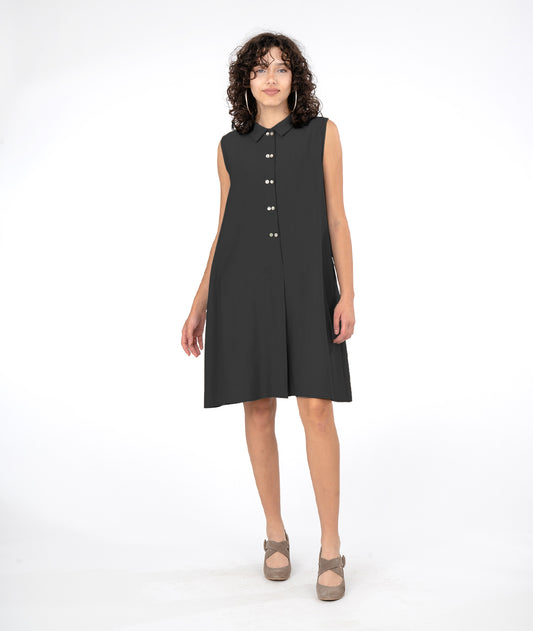 model in a black button down sleeveless shirt dress