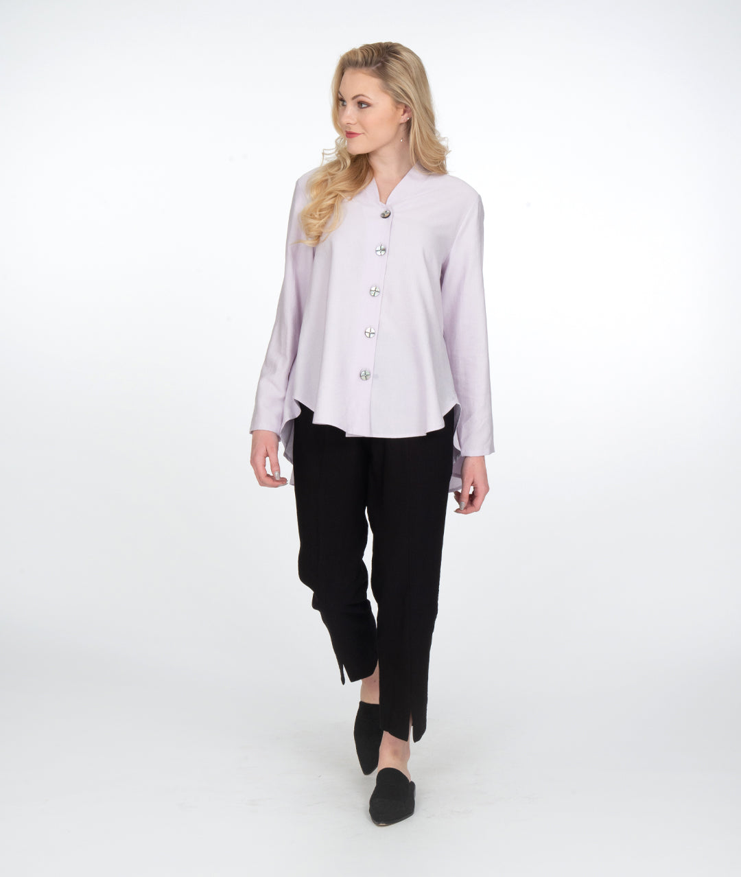 model in a slim black pant with a lilac button up blouse with a high low hem and a small standing collar