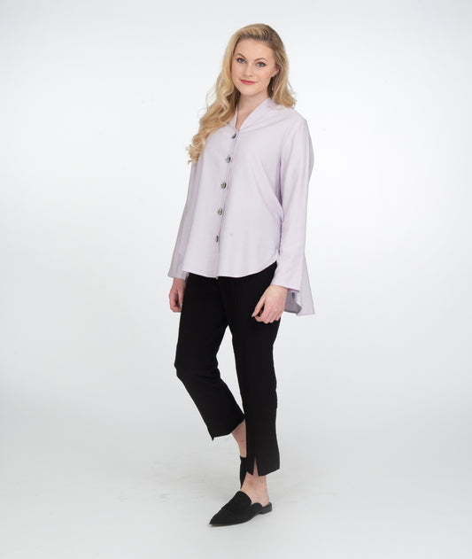 model in a slim black pant with a lilac button up blouse with a high low hem and a small standing collar