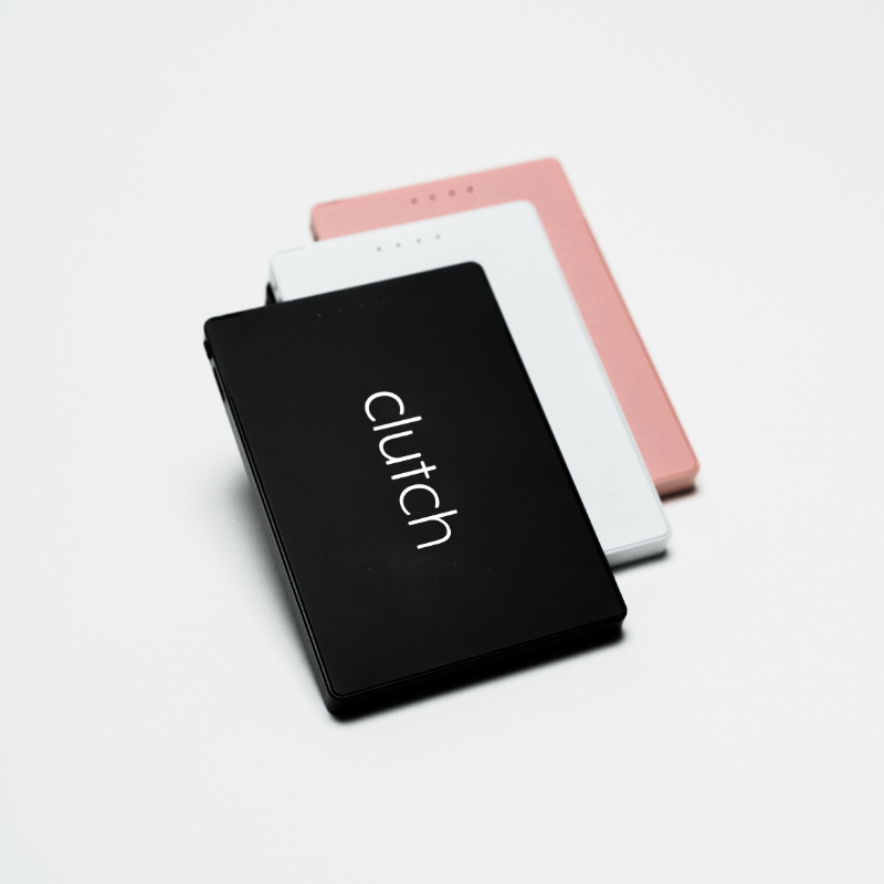 three portable chargers in black, white and pink