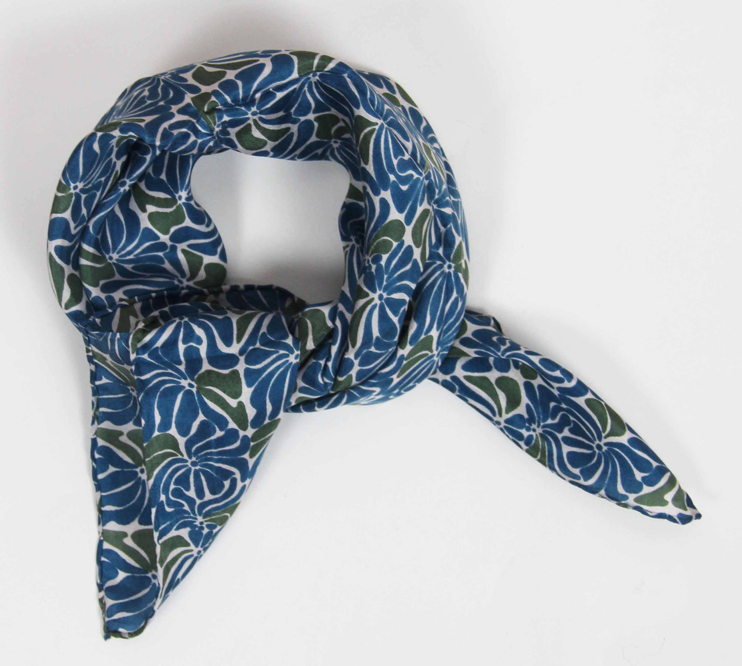 Blue and green patterned scarf on a white background