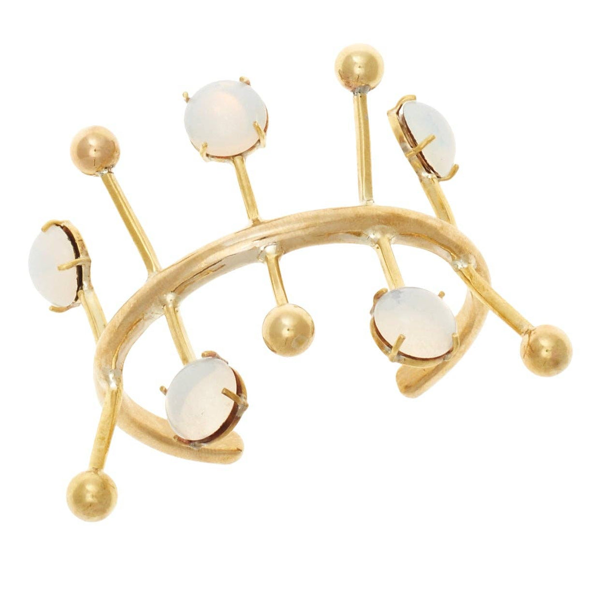 A gold-toned geometric cuff bracelet featuring five round, milky white gemstone accents set in gold, displayed on a clean white background.