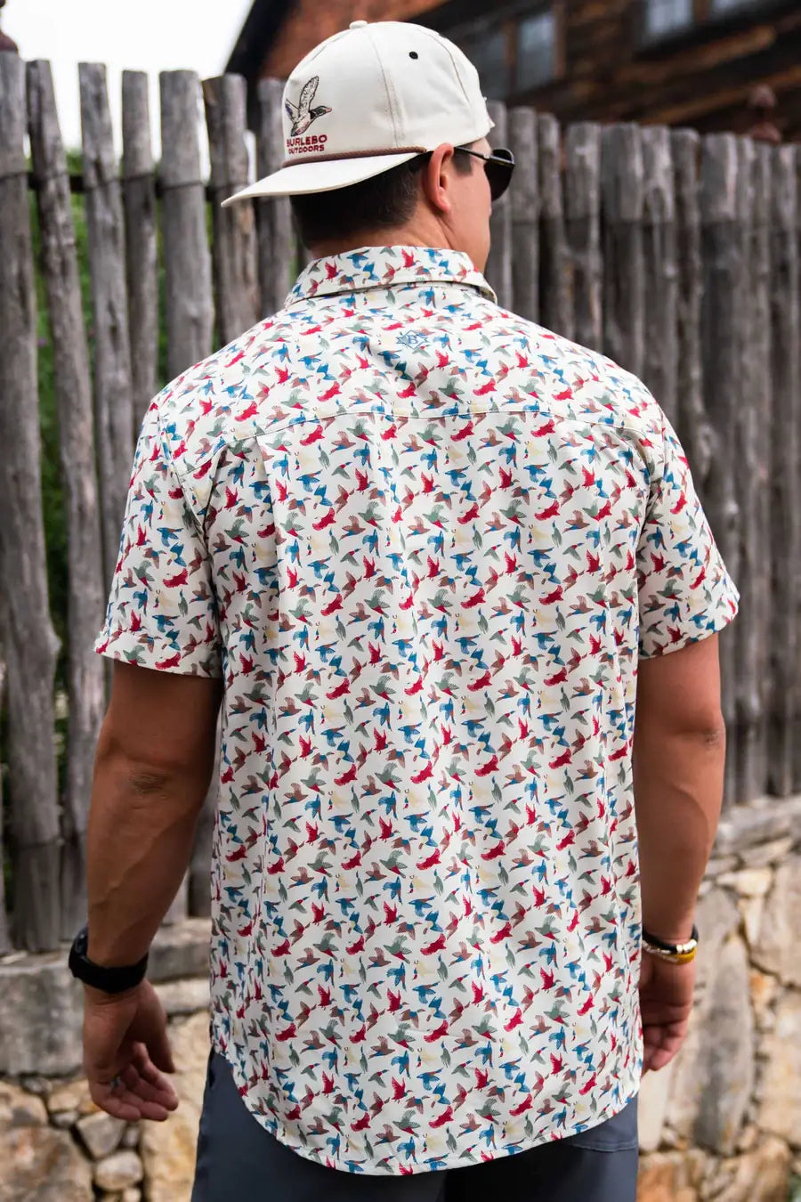 back view of male model wearing a patterned shirt