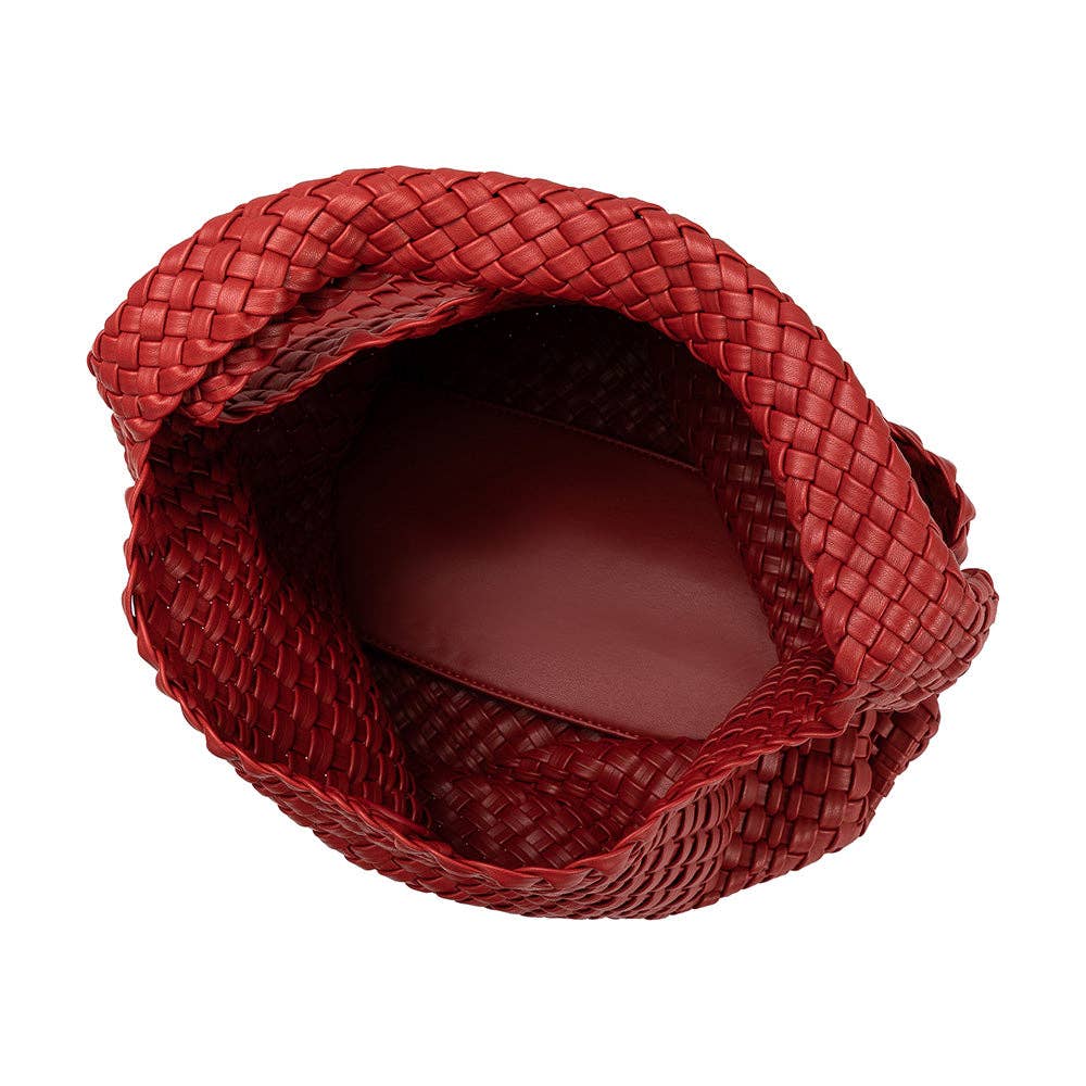 Interior of red woven handbag with small red zip pouch on a white background