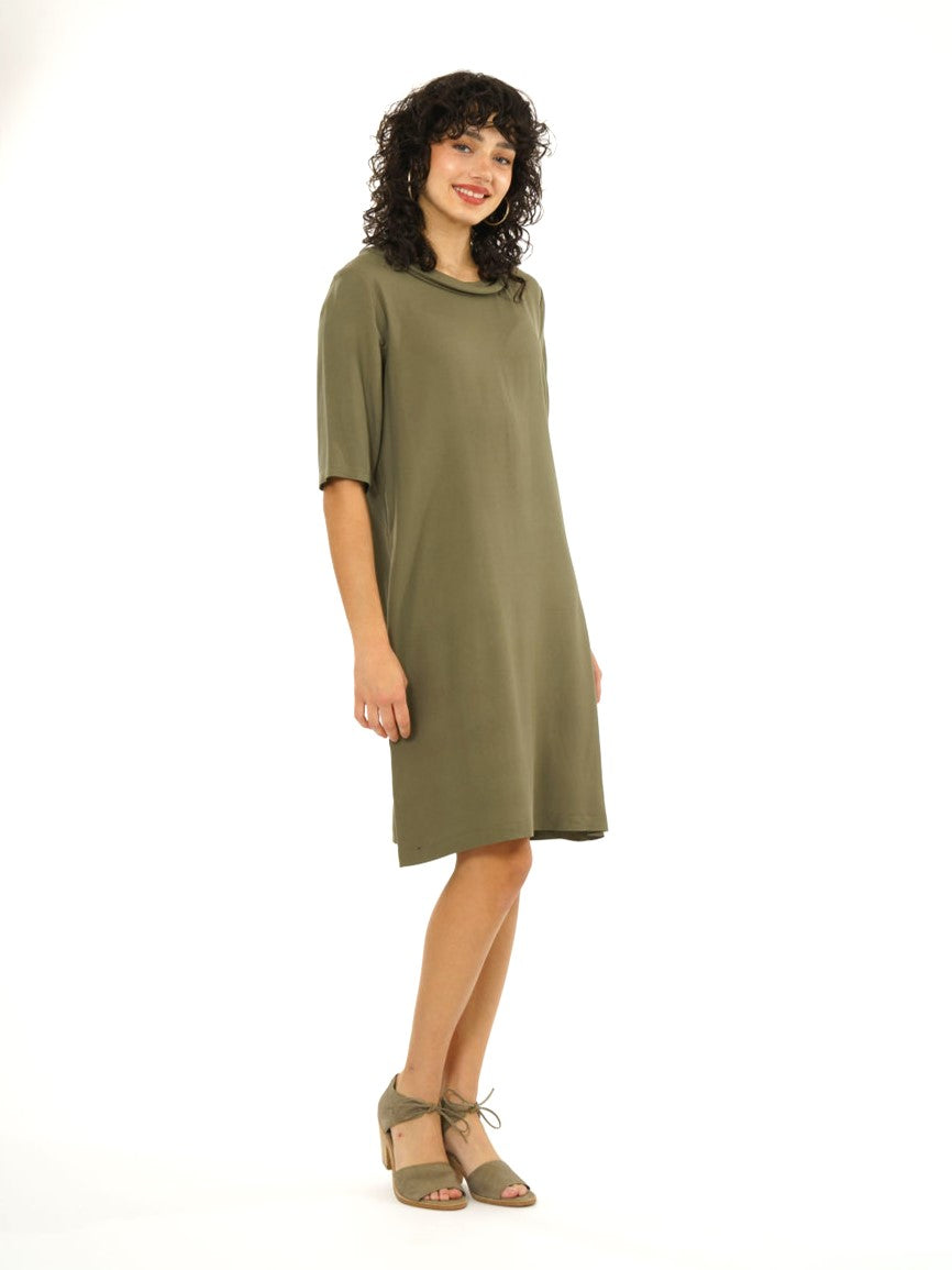 brunette model in knee length olive green dress  with elbow length sleeves and a split collar in the back. on white background