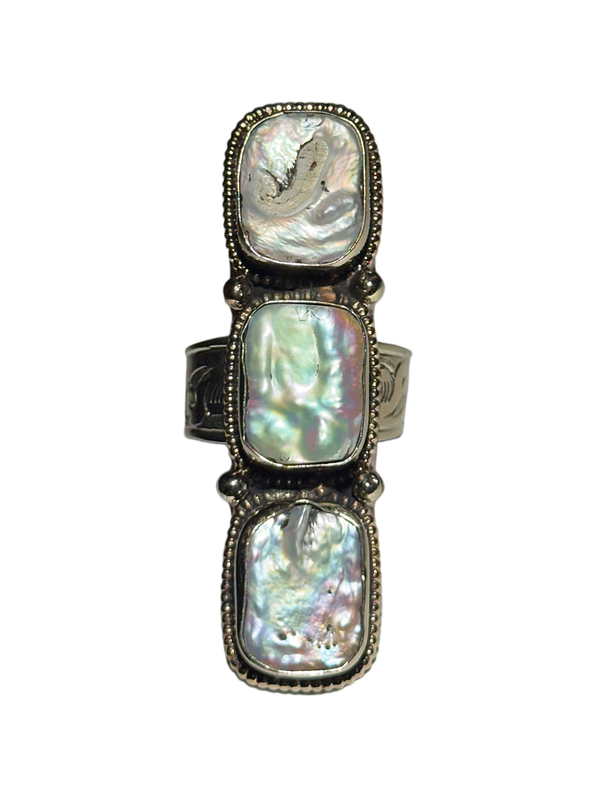 A silver-toned ring featuring three stacked, vertically oriented oval pearl stones in beaded silver settings, shown against a plain white background.