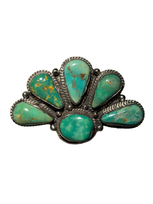 Turquoise stone ring with silver setting on a white background