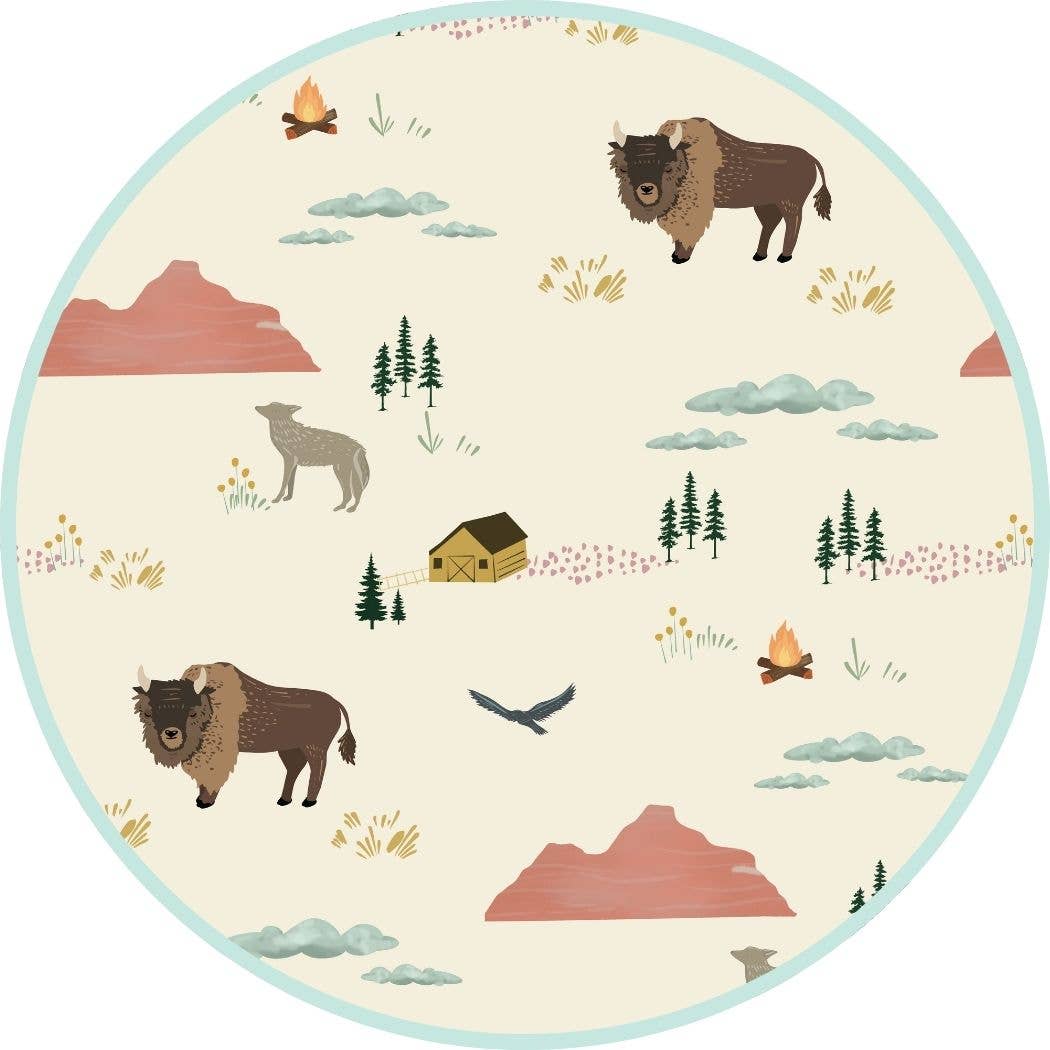 Round rug with nature-themed design featuring animals and landscapes.