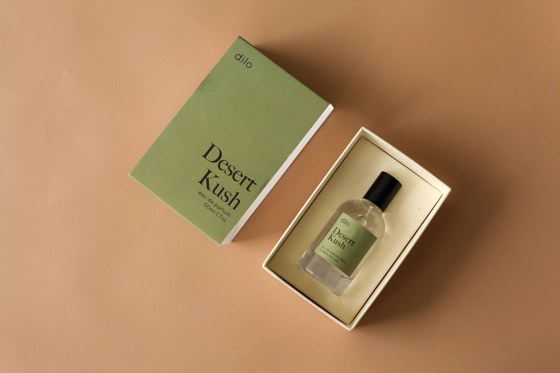Desert Kush perfume bottle and packaging on a brown background