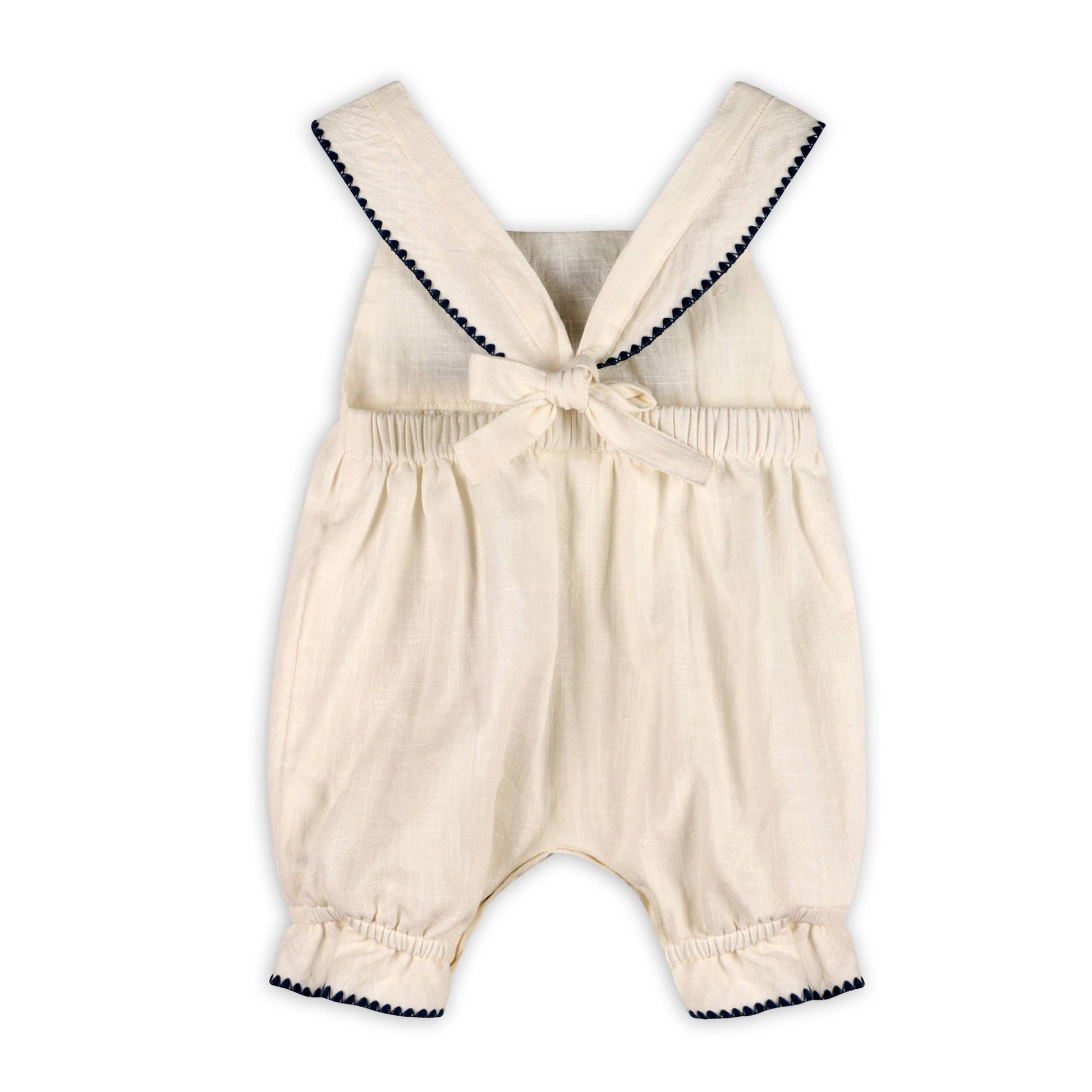 back of off white baby bubble jumper with navy embroidery and bow tie on back