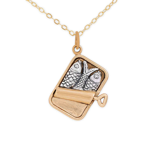 Gold necklace with a pendant featuring a fish design on a white background