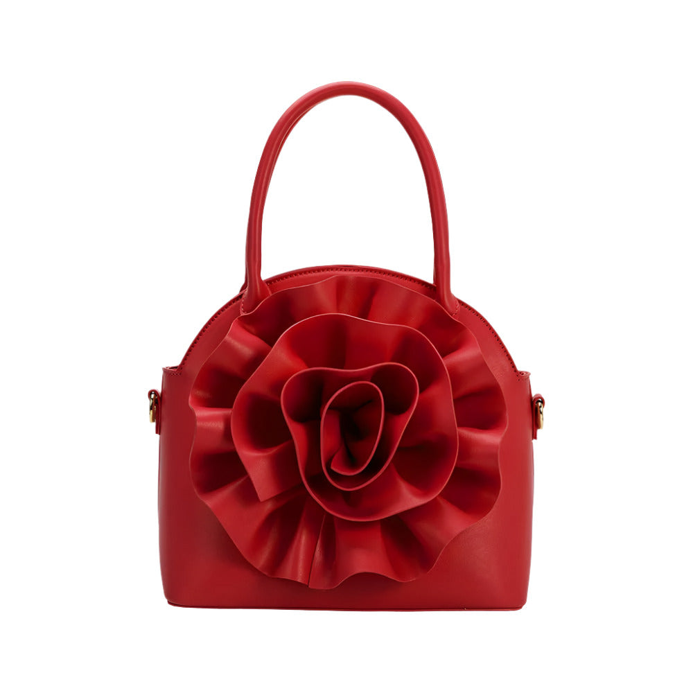 red handbag with large flower detailing on white background