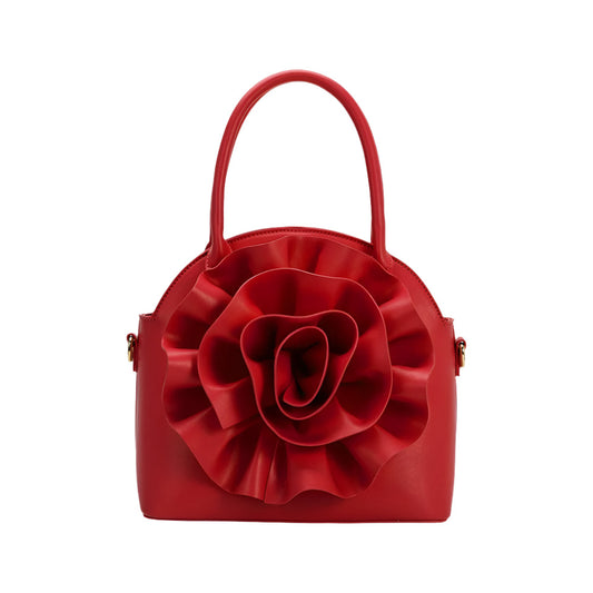 red handbag with large flower detailing on white background