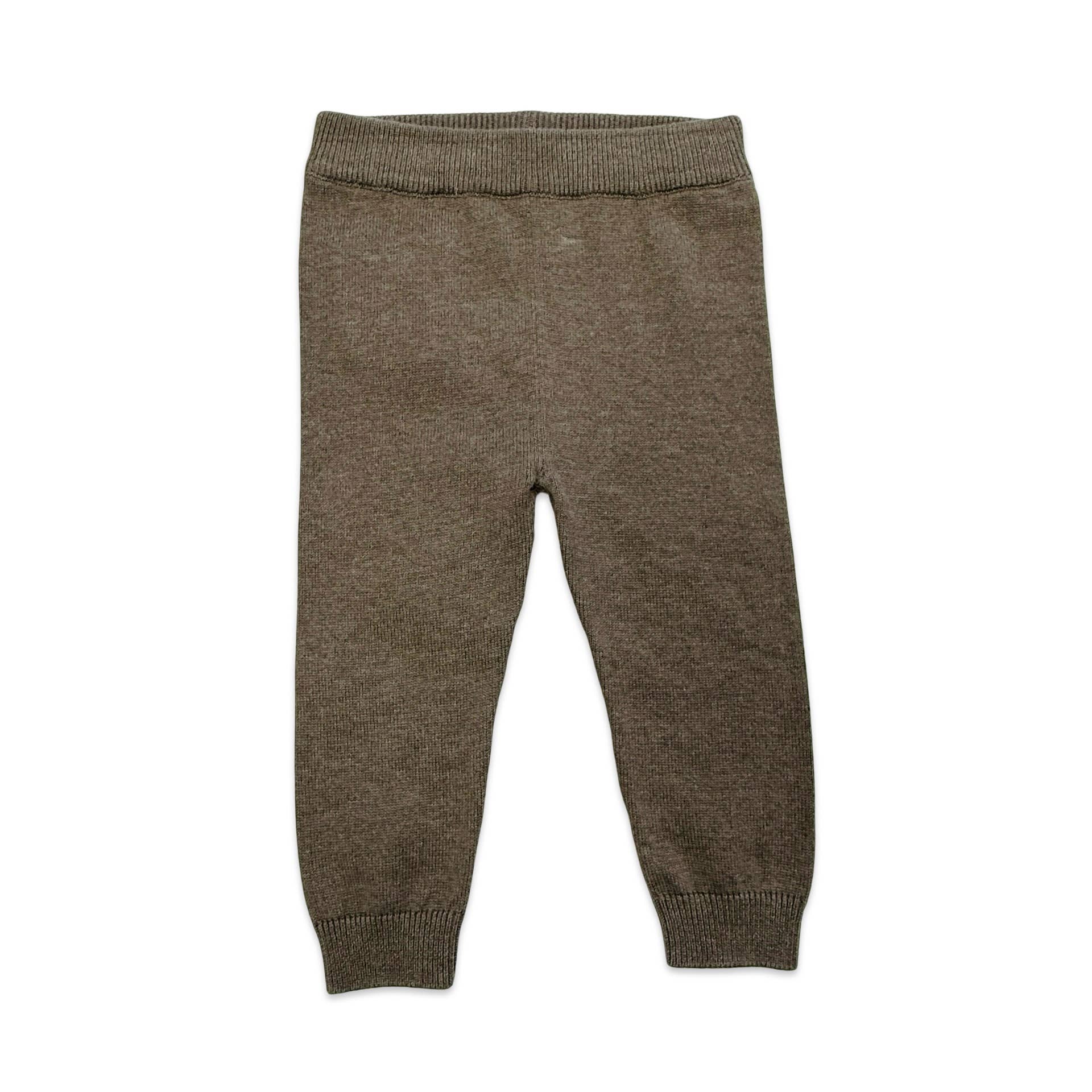 Brown knitted baby pants on a white background