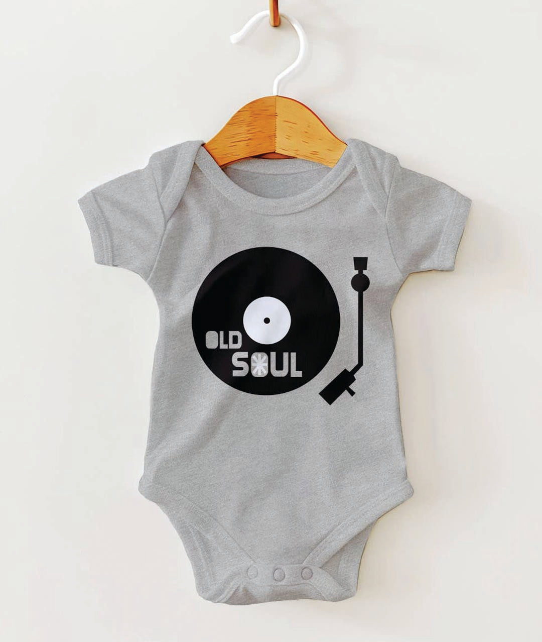 Gray baby onesie with a vinyl record design on a white background