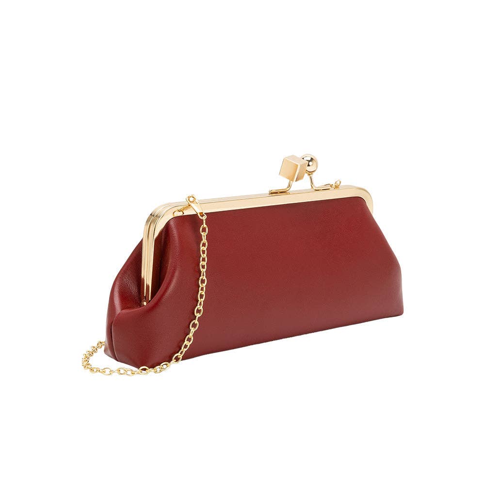 A burgundy leather kiss-lock clutch bag with a gold-tone metal frame and a gold chain shoulder strap, shown on a plain white background.