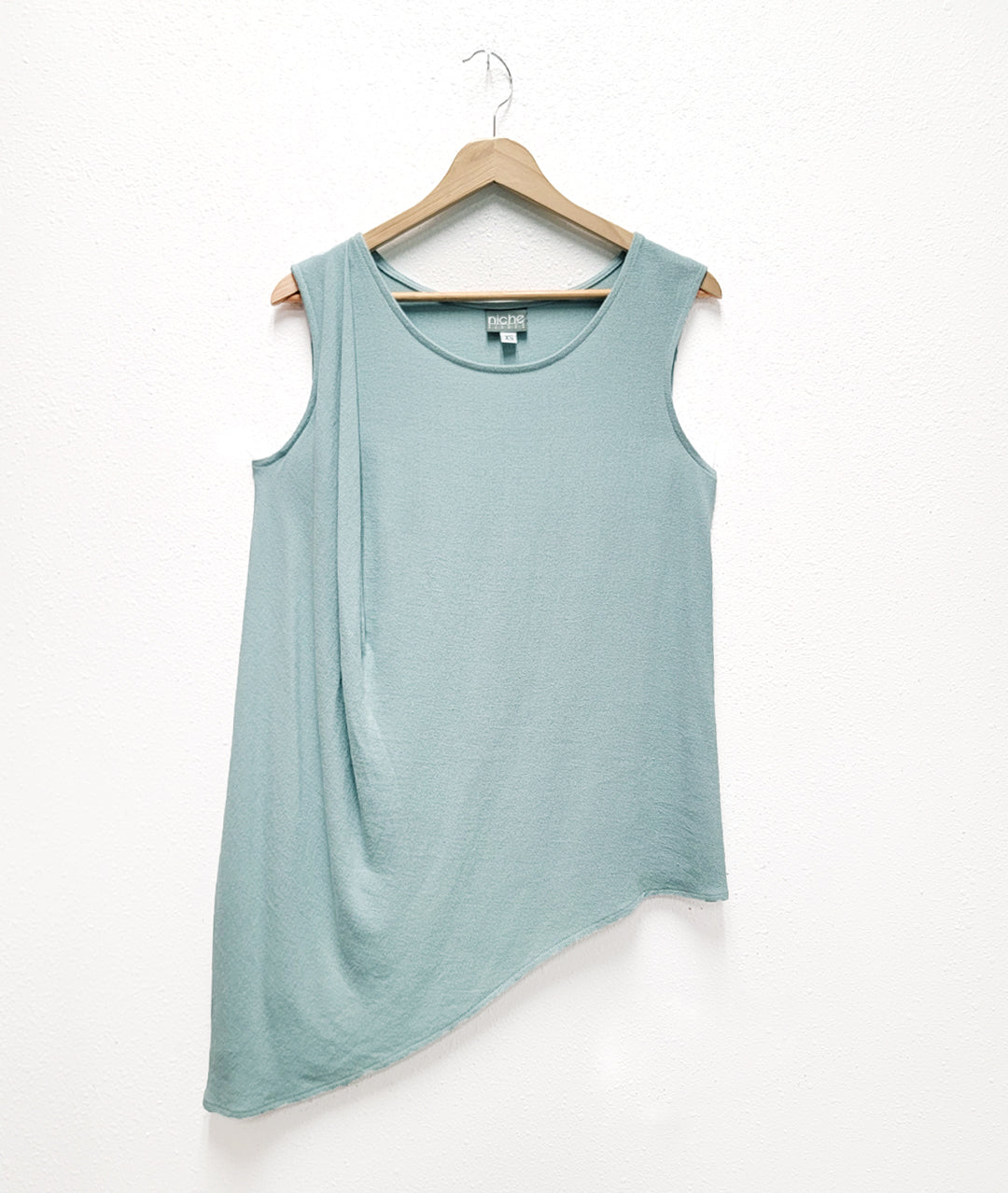 Light blue sleeveless top with beautiful gather at one shoulder and asymmetrical hemline
