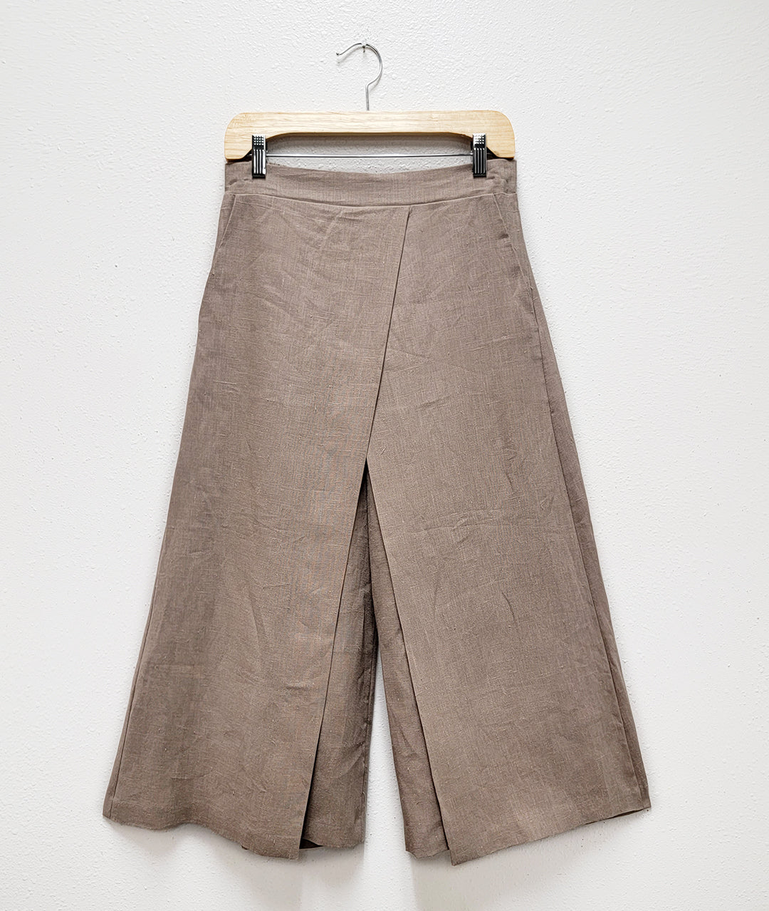 oatmeal color linen wide leg pant with an overlapping panel in the front from each leg