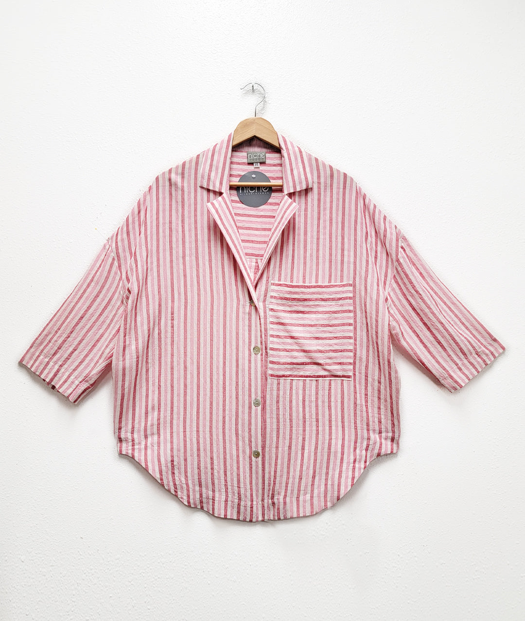red and white striped boxy fit shirt with round hem, drop shoulder and patch pocket. 