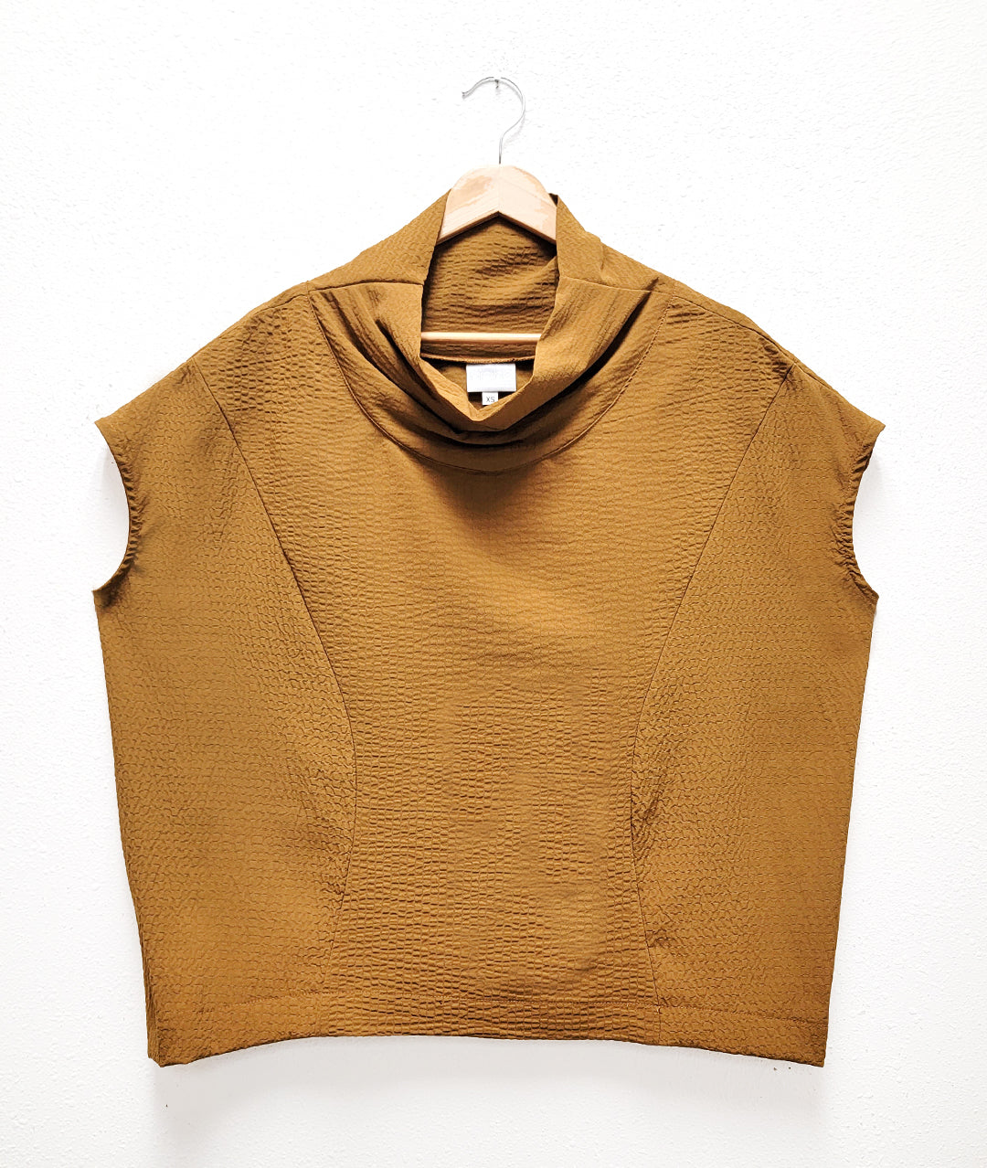 boxy dijon color pull over top with cap sleeves and a cowl neck