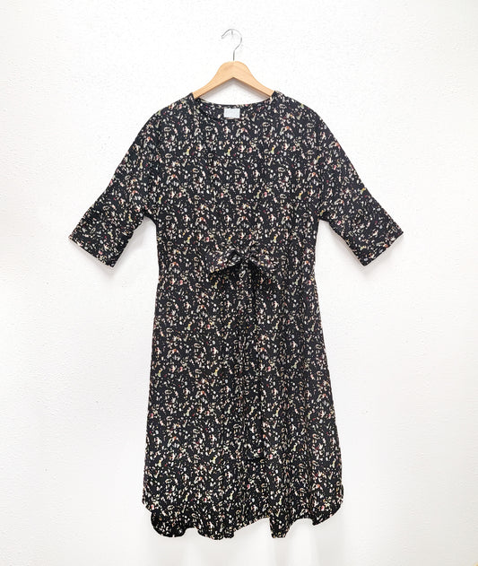 black terrazzo print dress with a kimono style sleeve and a center waist tie belt that can be worn in a number of ways