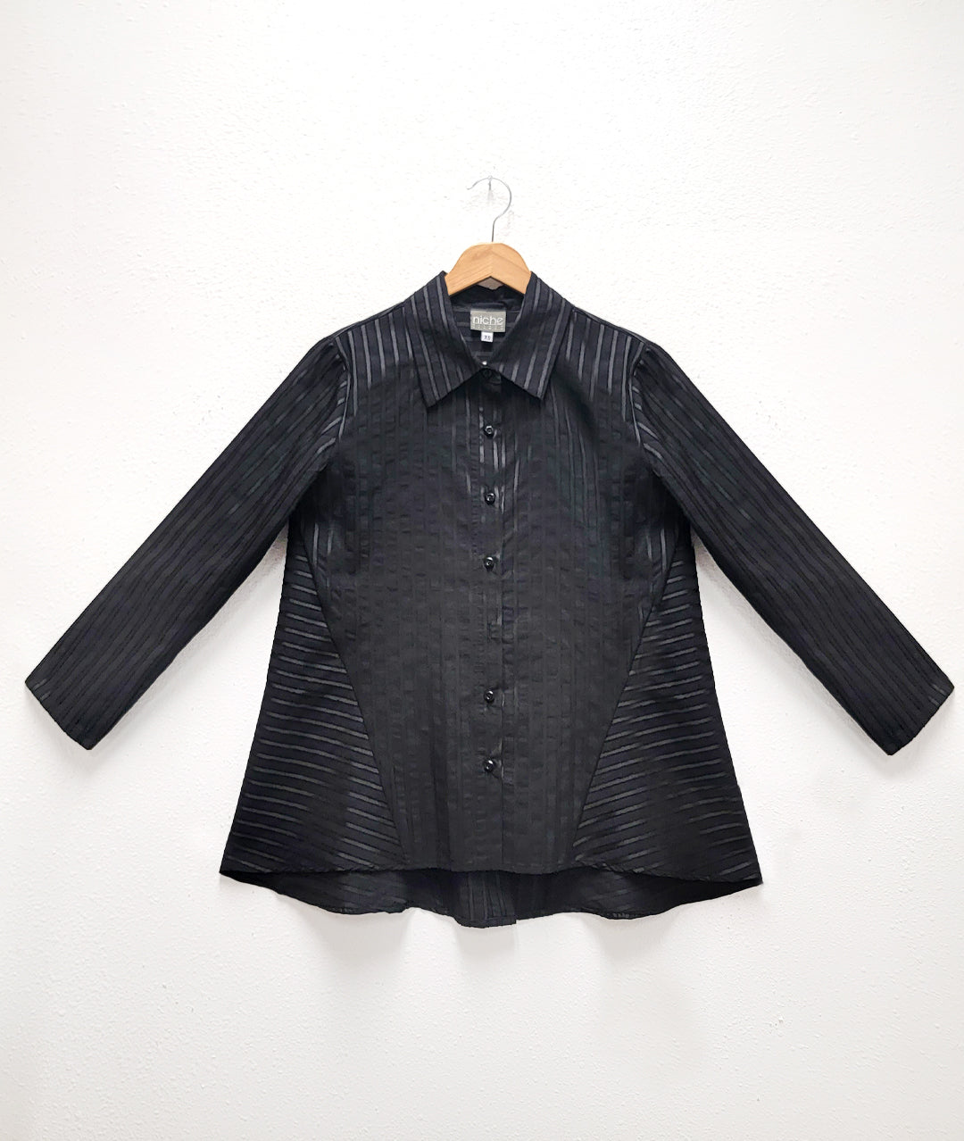 black on black striped blouse with a panel adding body on either side