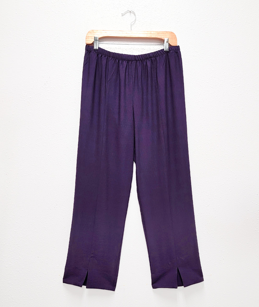 aubergine color straight leg pant with a center seam and split at each ankle