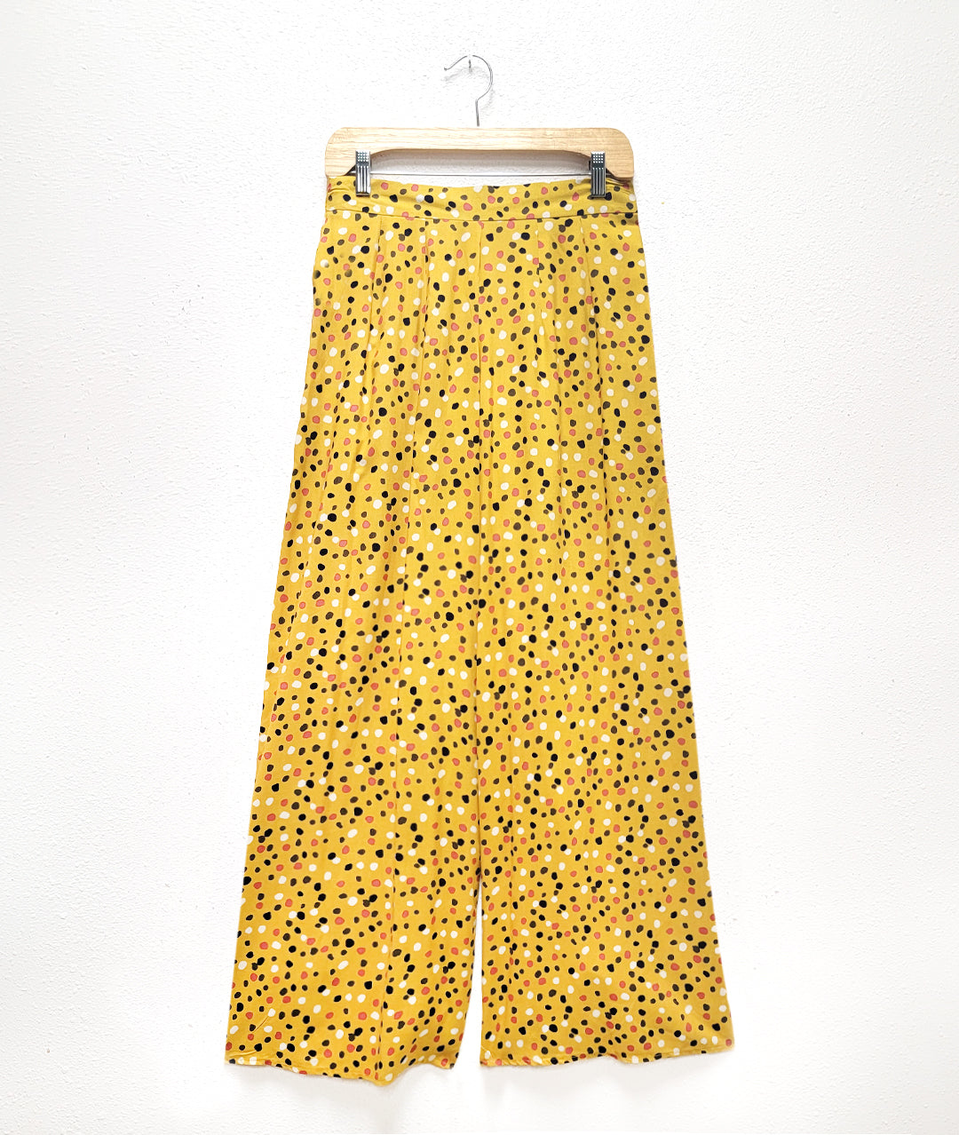 wide leg palazzo pant with a mustard background with a multicolor dot pattern