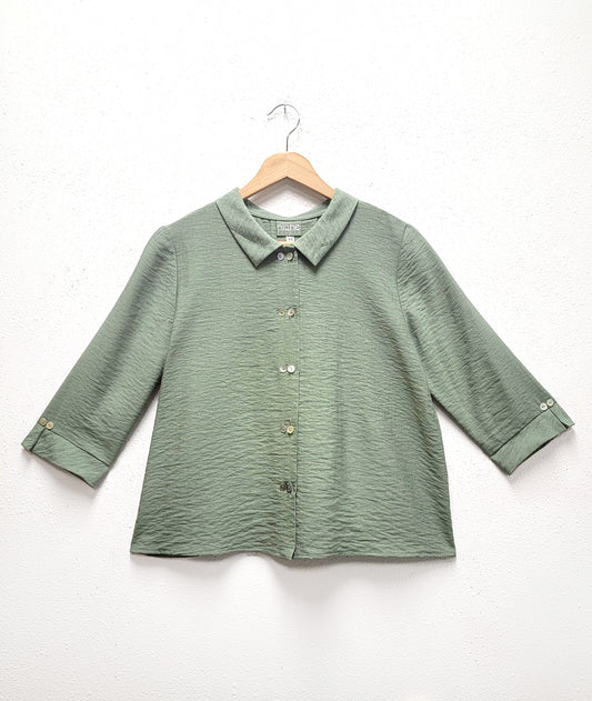 moss green button down blouse with a 3/4 sleeve and twin button detail