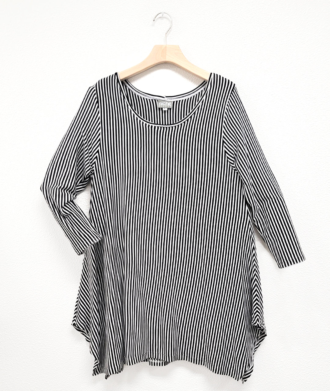 black and white vertical stripe tee with 3/4 sleeves and a hankerchief hem