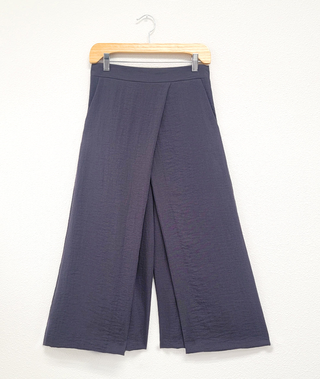 charcoal blue pant with A-line shape and crossover apron front. Flat band front, elastic back waist. Pockets in side seams