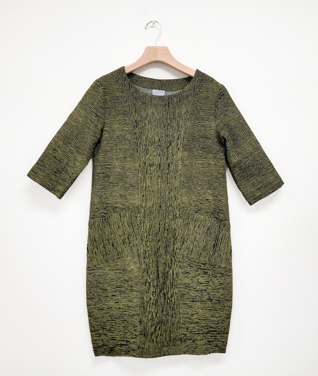 green and black short sleeve shift dress with princess seams and a contrasting center panel