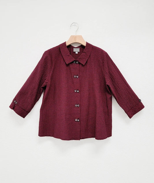 3/4 sleeve red and black stripe top with "twin" buttons, collar, and buttons at end of sleeves against white background