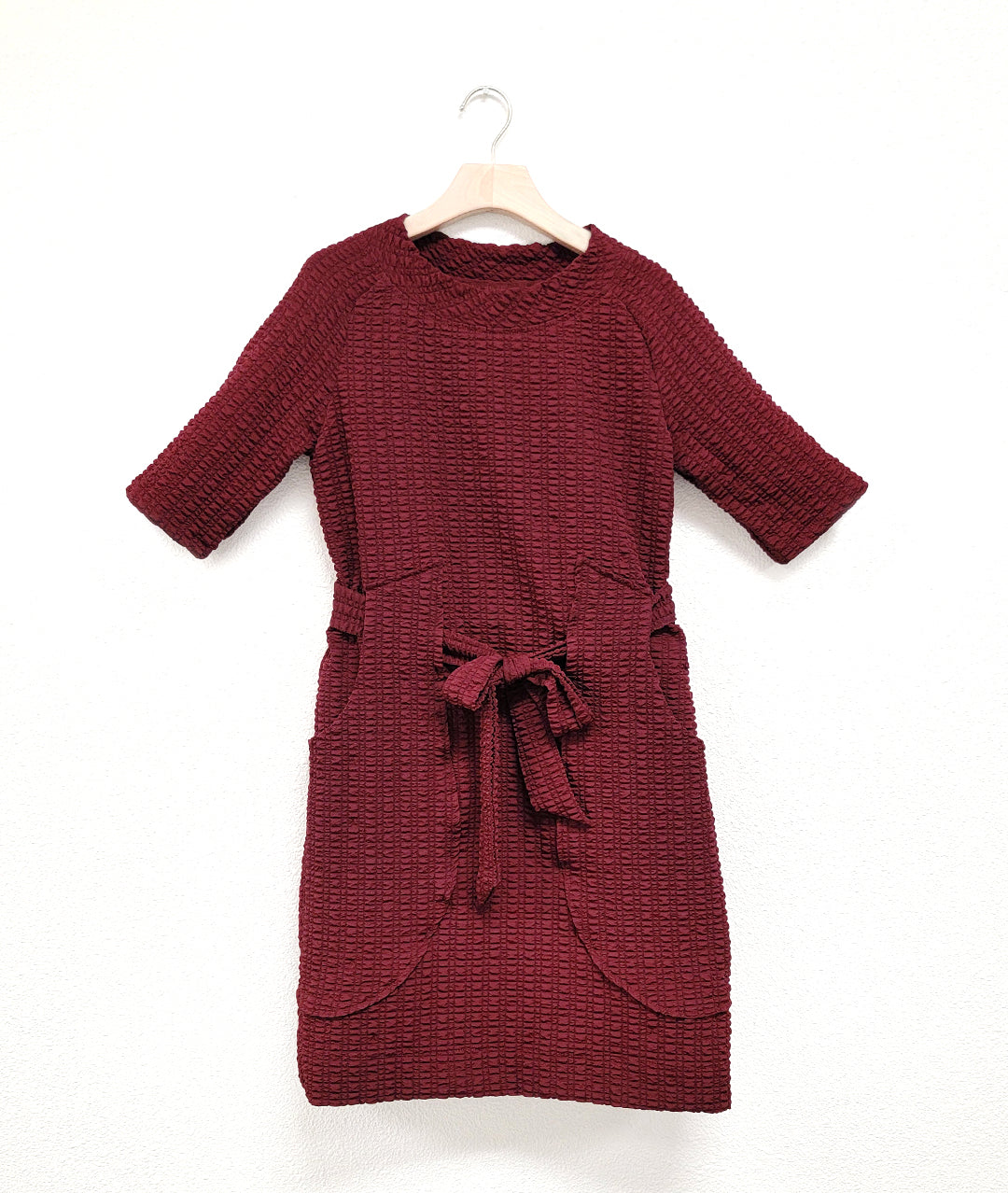 merlot color raglan sleeve shift dress with a matching tie belt at the waist, which runs through exterior pocket loops