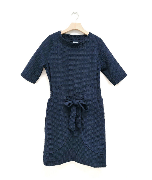 dark blue raglan sleeve shift dress with a matching tie belt at the waist, which runs through exterior pocket loops