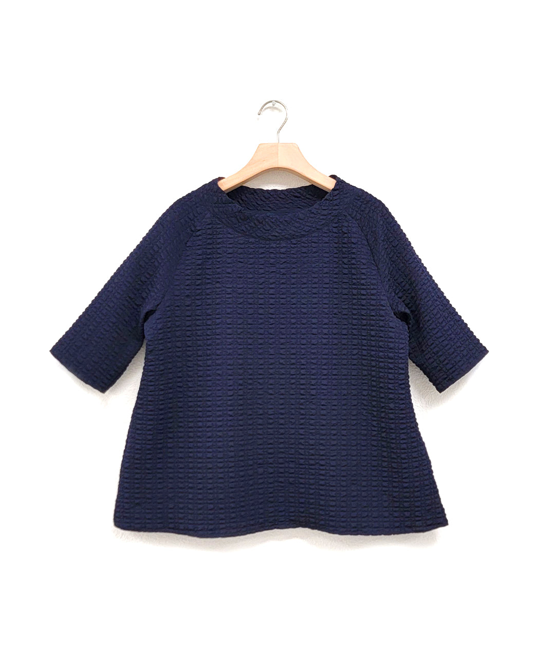 dark blue boxy pullover top with short raglan sleeves, a standing collar and a straight hem