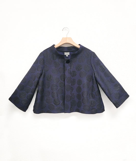 dark blue jacket with black dots and single button on hanger with white background.